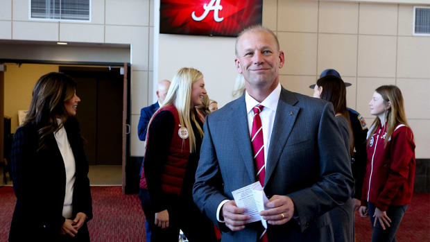 Kalen DeBoer smiles at his Alabama introductory press conference.